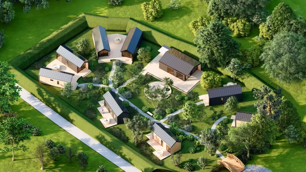 Drone-opname van een vakantiepark met zes huisjes en een bruggetje.